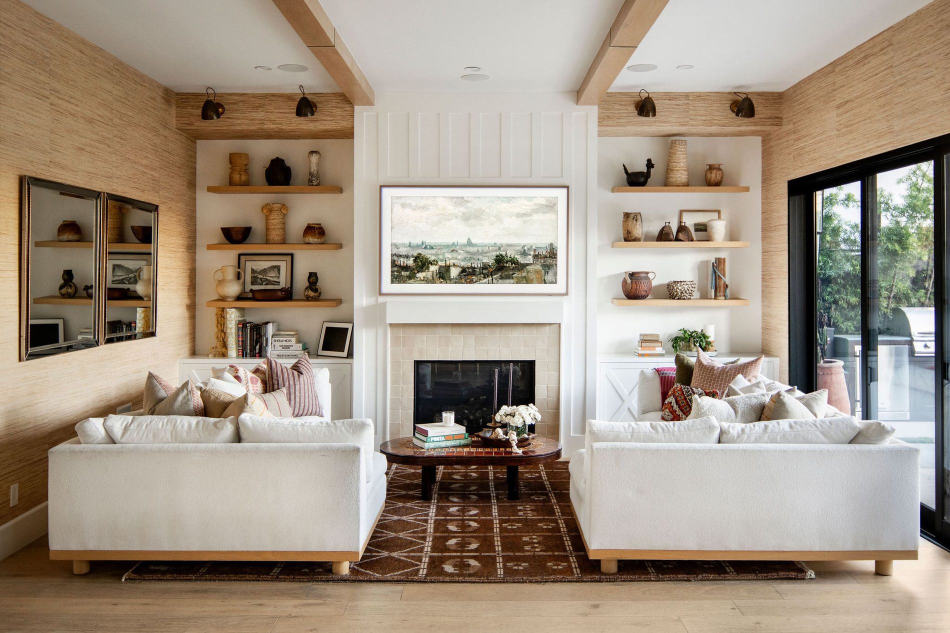 A wide view across an open living and kitchen space in daylight.